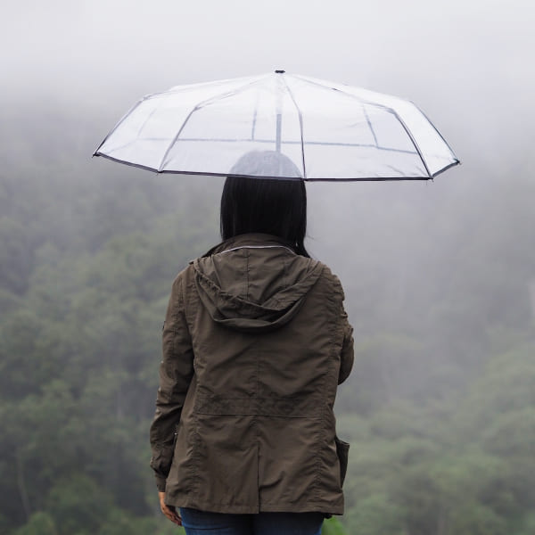 woman-tourist-hold-umbrella-green-rain-forest-background